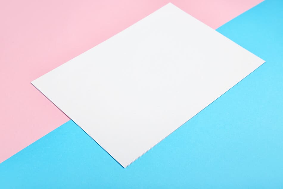 papel blanco sobre fondo azul y rosa
